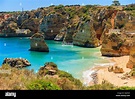 View of famous Praia Dona Ana beach with turquoise sea water and cliffs ...