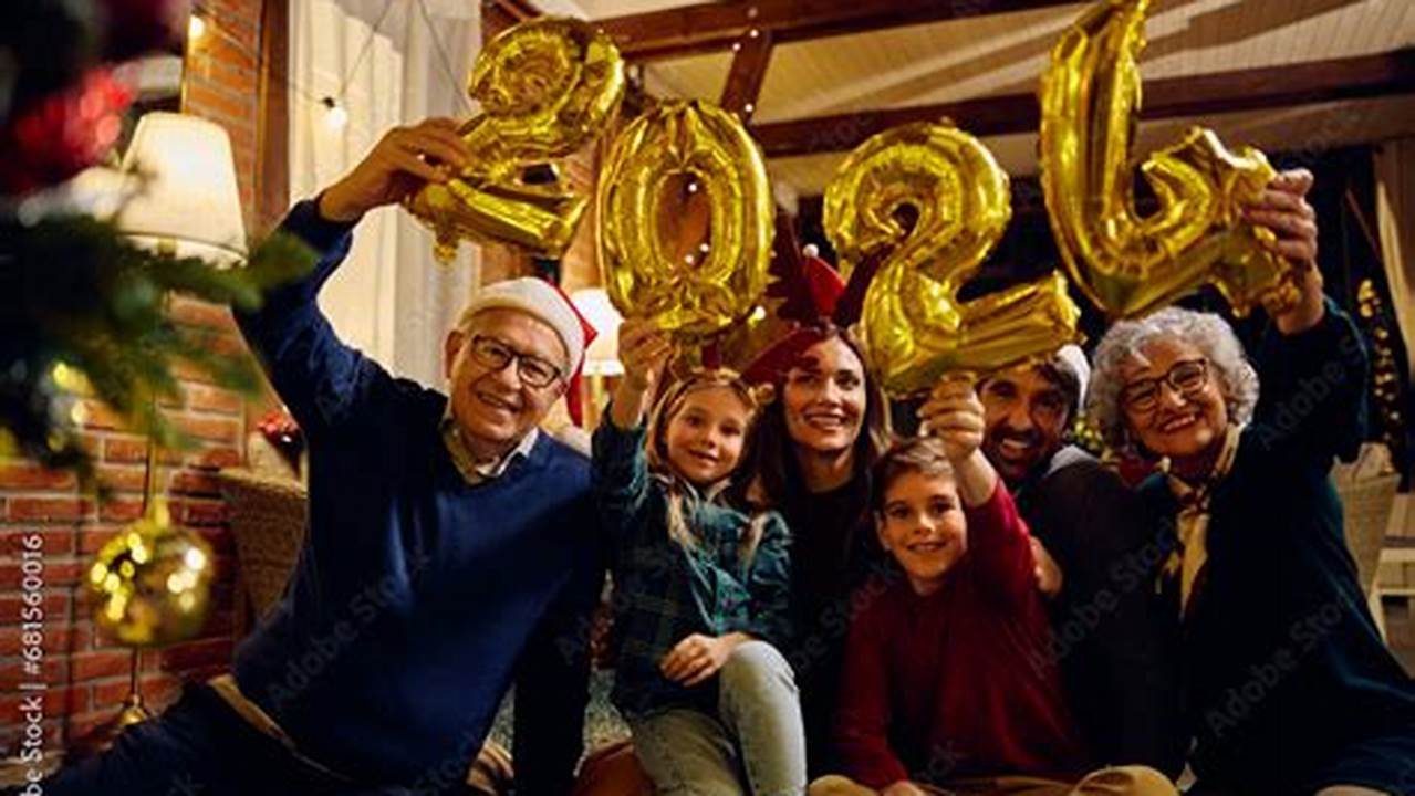 Portrait Of Happy Multigeneration Family Celebrating New Year While Holding 2024 Balloons And Looking At Camera., 2024