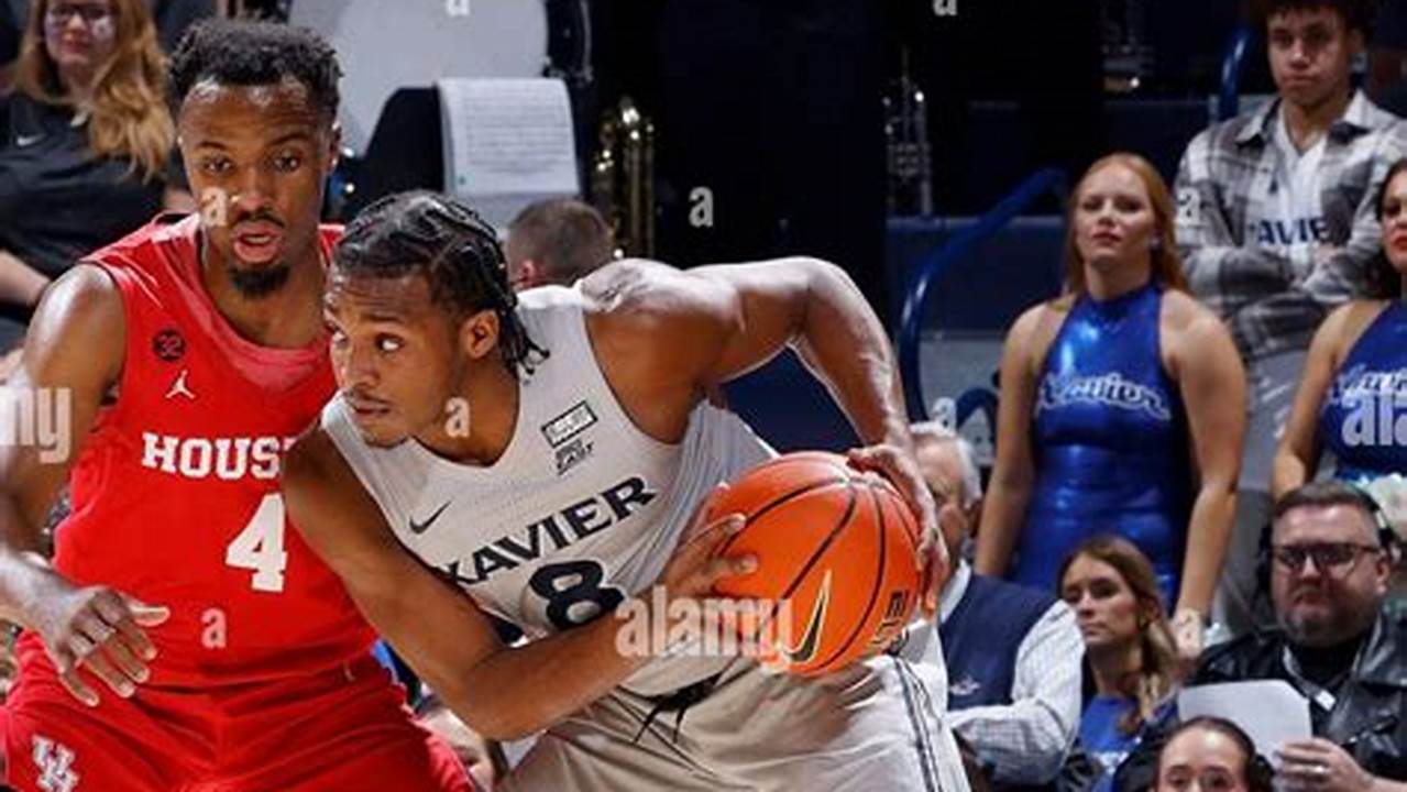 Quincy Olivari #8 Of The Xavier Musketeers Handles The Ball Against Lj Cryer #4 Of The Houston Cougars At Cintas Center On December 01, 2023 In., 2024