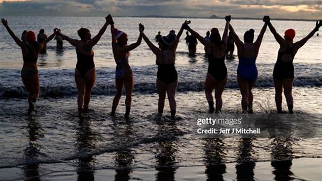 Swimmers Take Part In A Sunrise Dip In The North Sea At Portobello Beach Near Edinburgh To Mark International Women’s Day Photograph, 2024