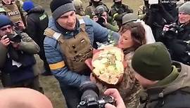 Vitali Klitschko kisses bride as he attends military field wedding