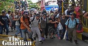 Migrant caravan in Guatemala breaks through border fence into Mexico