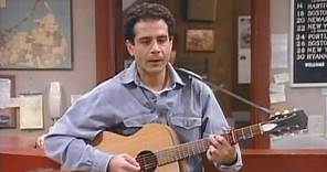 Tony Shalhoub plays guitar and sings in Wings