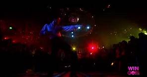 John Travolta's famous disco dance scene in the movie 'Saturday Night Fever'.