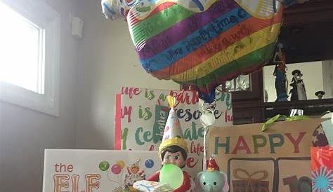a birthday party with balloons, greeting cards and a cat in the hat