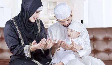 Arabic Parents Kissing Their Son Cheek At Home RoyaltyFree Stock Image