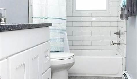 This white bathroom features a unique white and gray tile pattern, a