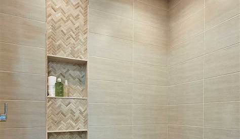 The marble subway tile that lines the walls of the shower in this