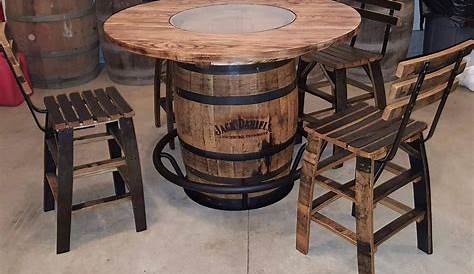 a table made out of wine barrels with chairs around it and two stools