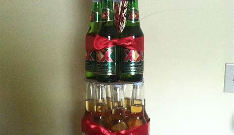 a christmas tree made out of beer bottles and wrapped in red white and