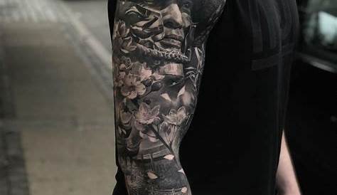 a man with a full sleeve tattoo on his arm