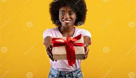 Black Woman Holding Gift Wrapped Stock Photo Dissolve