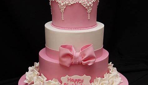 two tiered black and pink cake with roses on the bottom, decorated with