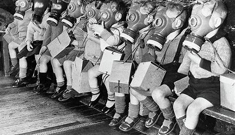Toddlers on bench in gas masks during WWII ~ vintage everyday