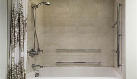 Huge tiled shower with free standing deep soaker tub in custom home by