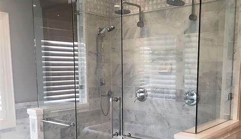 Dual shower heads in this large walk-in, tiled master shower in the