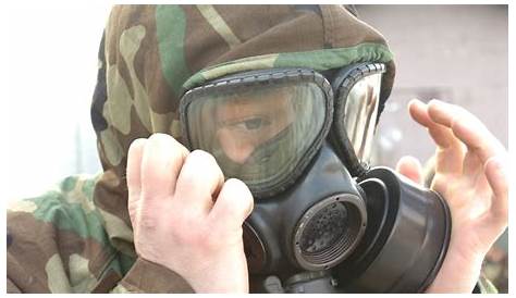 Close-up Portrait of a Man in a Gas Mask and Protective Dark Glasses in