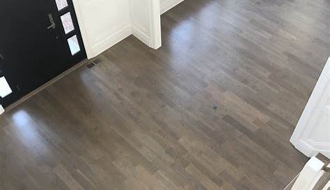 Grey floors with natural wood undertones and whites create a sense of