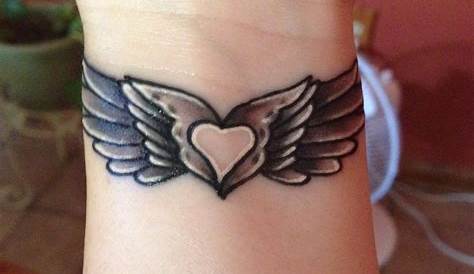 My angel wing tattoo with a heart in the middle | Wing tattoos on wrist