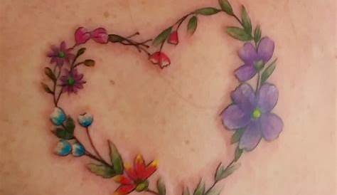 Heart and flowers tattoo on shoulder | Heart flower tattoo, Small heart