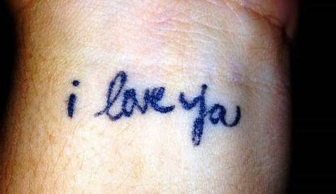 Wrist matching tattoo saying “I love you” in sign