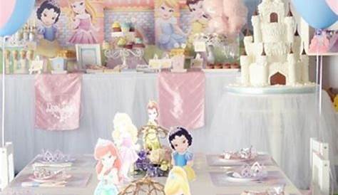 Child sized tables and chairs decorated in a pink princess theme for a