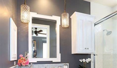 a white sink sitting under a bathroom mirror