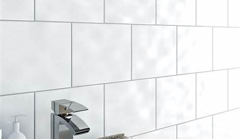 Bathroom large matt white tiles on wall, black penny round mosaic