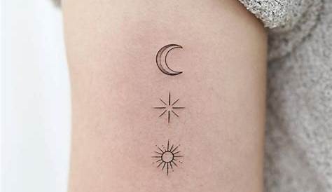 Sun, moon and stars tattoo on the upper back.