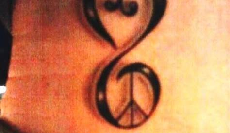 a couple of hearts tattoo on the left side of the arm, with an