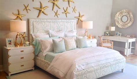 under the sea themed bedroom with a coral print upholstered bed & gold