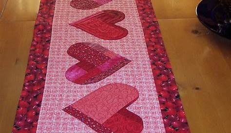 Valentine Table Runner Free Pattern A Quilted With Red And White Hearts On It Next To A