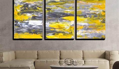 three black and white paintings hanging on the wall above a couch in a