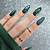 Autumnal Whimsy: Embrace the whimsical beauty of dark green nail designs