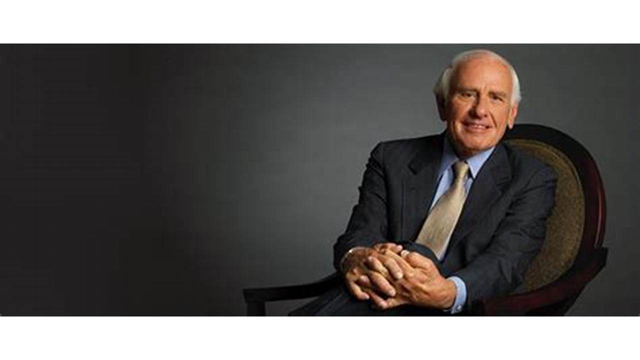 Jim Rohn standing with microphone