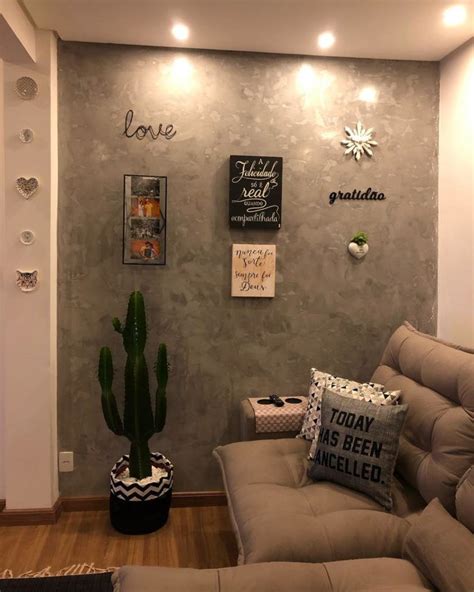 A Living Room Filled With Furniture And A Cactus In A Pot On The Floor