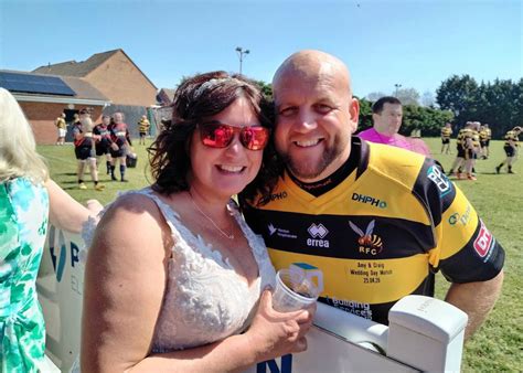 Rugby-loving bride cheers husband on in wedding dress