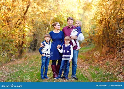 Portrait Of Young Parents With Three Children Mother Father Two Kids