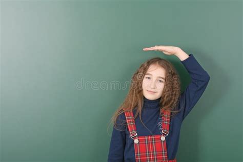 Schoolgirl Near Green School Board Young Playful Girl Holds His Hand Over His Head Stock Image