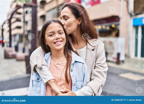 Woman And Girl Mother And Daughter Hugging Each Other And Kissing At