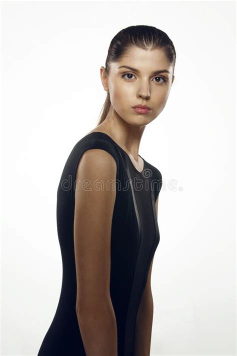 Front View Of A Slim Brunette Model In Elegant Black Dress With Tight