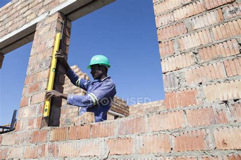 African Builder Working On Construction Site — Brickwork Spirit Level