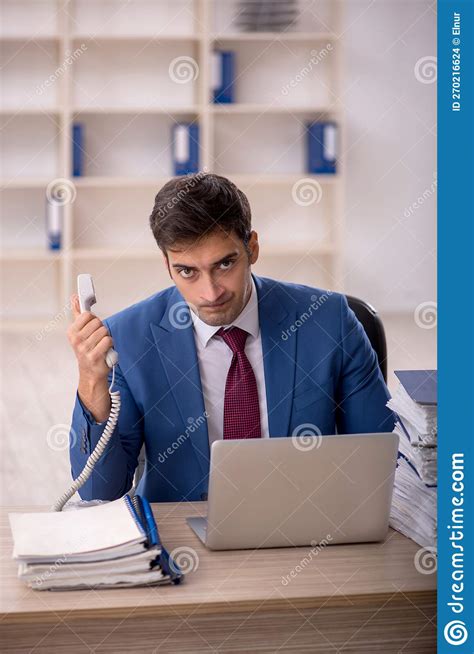 Young Male Employee And Too Much Work In The Office Stock Photo Image