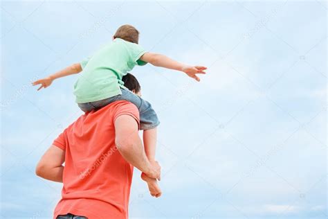 Father Carrying Son On Shoulders Father Carrying His Son On Shoulders