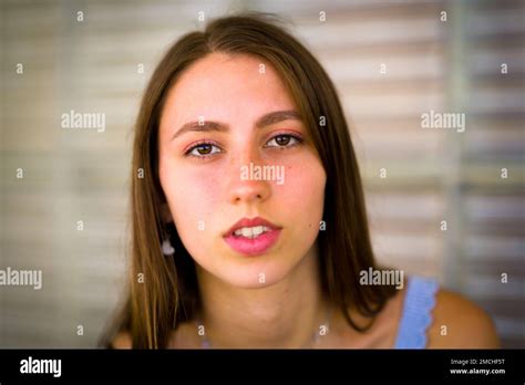 Close Up Portrait Of Teenage Girl Leaning Against Art Deco Glass Brick