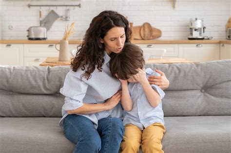 Joven Madre Consuela A Hijo Llorando Foto Premium