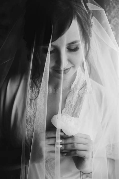 Beautiful Stylish Brunette Bride Posing In Silk Robe Under Veil In The