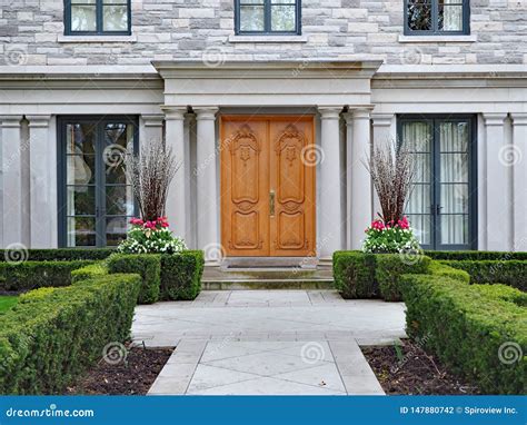 Large Suburban House With Stone Columns And Hedge Stock Photo Image