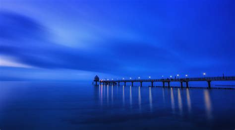 Dock Near Body Of Water During Night Time Blue Horizon Dock Body Of