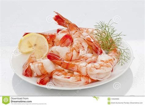 Steamed Jumbo Headless Shrimps With Deli Leaves And Lemon On White